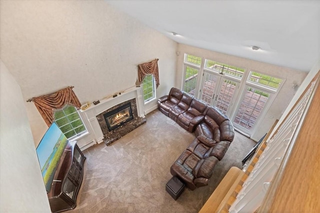 carpeted living room with a fireplace and french doors