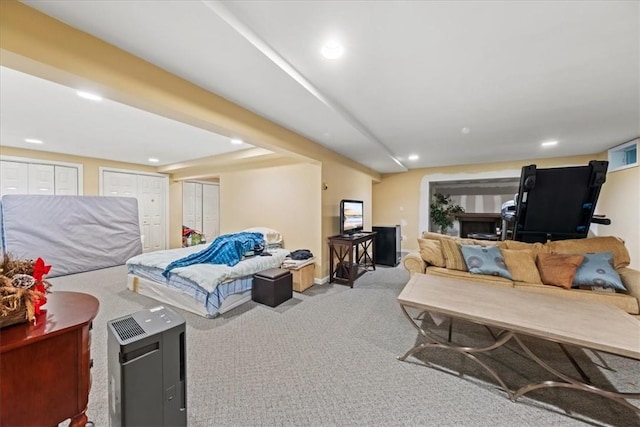 carpeted bedroom featuring multiple closets