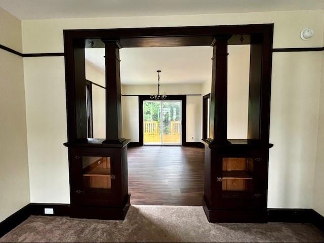 doorway with dark wood-type flooring