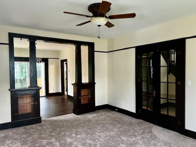 carpeted spare room featuring french doors, ceiling fan, and a baseboard heating unit