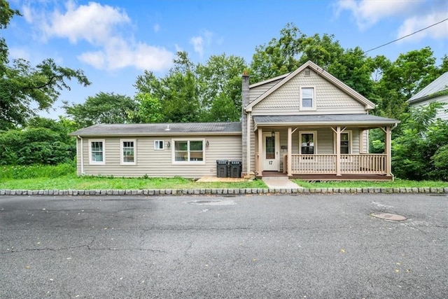 view of front of home with covered porch and central AC