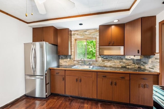 kitchen featuring dark hardwood / wood-style flooring, tasteful backsplash, sink, range, and stainless steel refrigerator