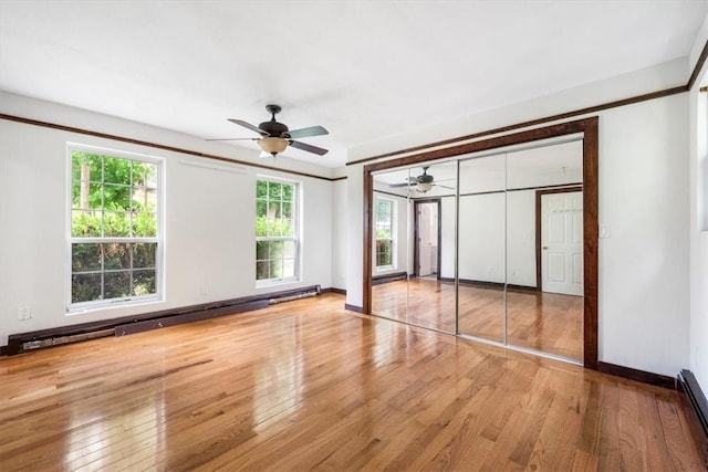 unfurnished bedroom with light hardwood / wood-style flooring, multiple windows, and ceiling fan