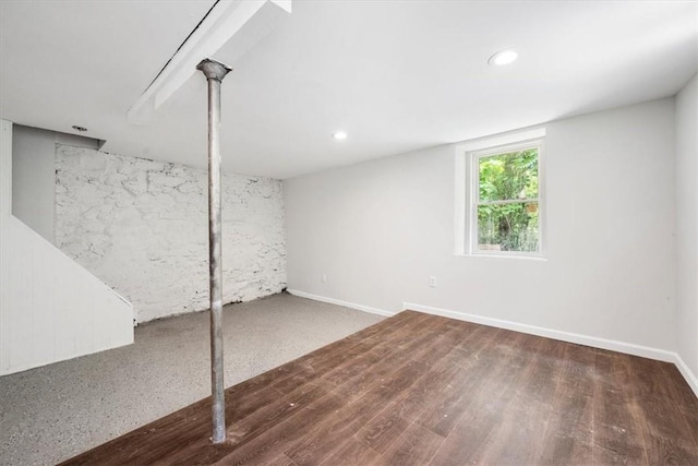 basement with dark hardwood / wood-style flooring