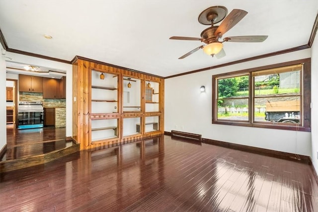 spare room with ceiling fan, dark hardwood / wood-style flooring, and ornamental molding