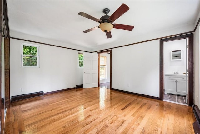 empty room with ceiling fan, sink, and light hardwood / wood-style flooring