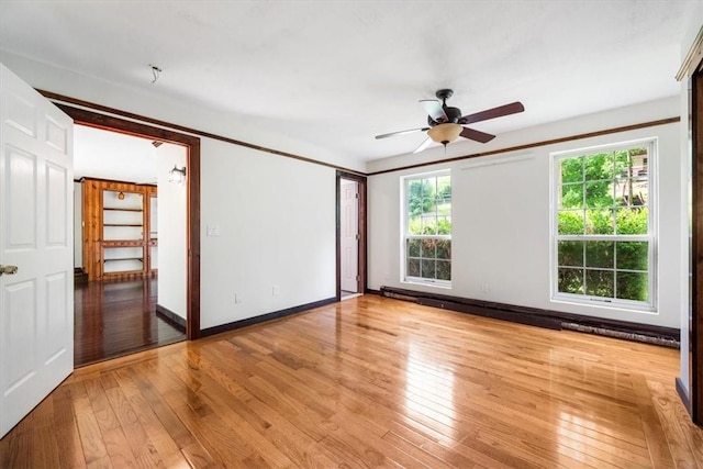 spare room with ceiling fan, plenty of natural light, and light hardwood / wood-style floors