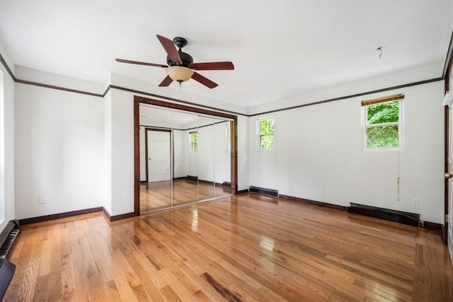 empty room with hardwood / wood-style flooring, ceiling fan, and a healthy amount of sunlight