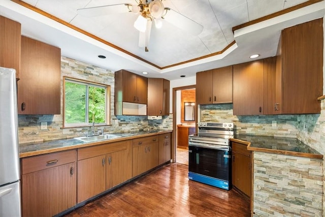 kitchen featuring backsplash, a raised ceiling, sink, dark hardwood / wood-style floors, and stainless steel appliances