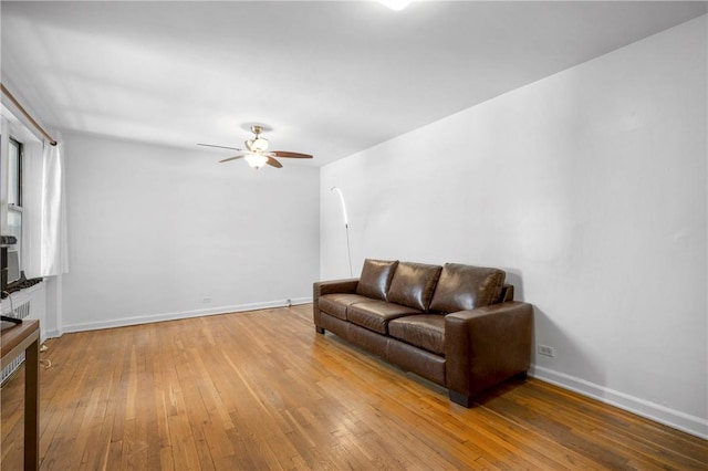 living room featuring hardwood / wood-style floors and ceiling fan