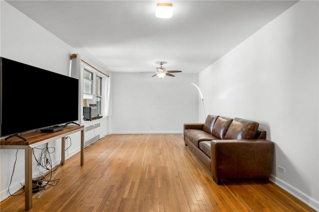 living room with ceiling fan and light hardwood / wood-style flooring