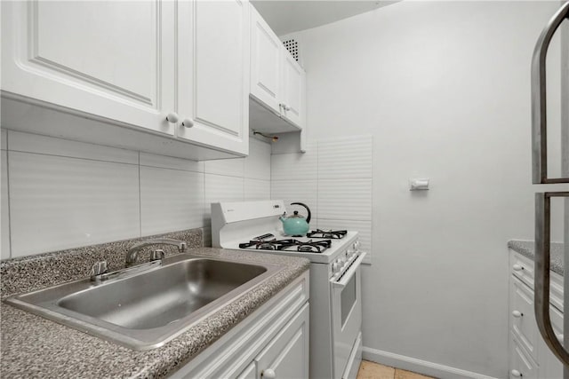 kitchen with white cabinetry, sink, white range with gas cooktop, and tasteful backsplash