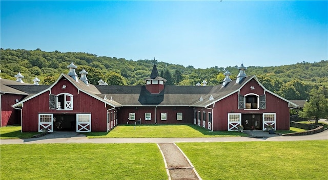 rear view of house with a yard and an outdoor structure