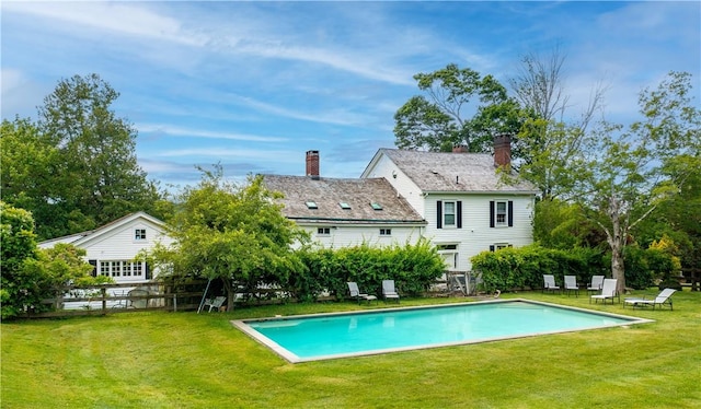 view of swimming pool featuring a lawn