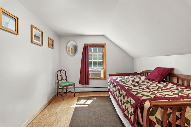 bedroom featuring hardwood / wood-style flooring, vaulted ceiling, baseboard heating, and cooling unit