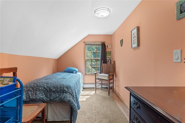 carpeted bedroom featuring baseboard heating and vaulted ceiling