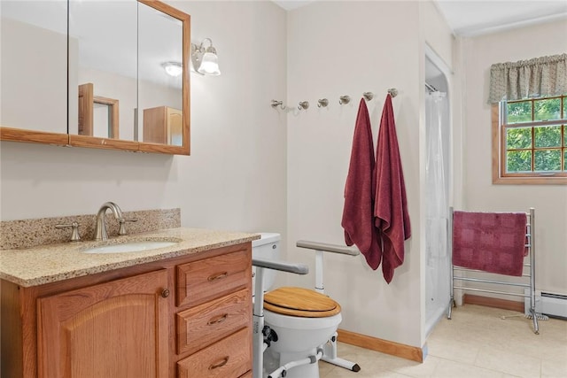 bathroom featuring tile patterned floors, vanity, and toilet