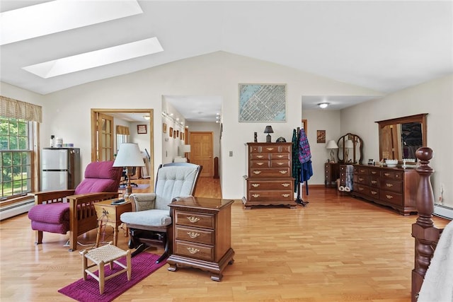 living area with a baseboard radiator, light hardwood / wood-style flooring, and vaulted ceiling with skylight