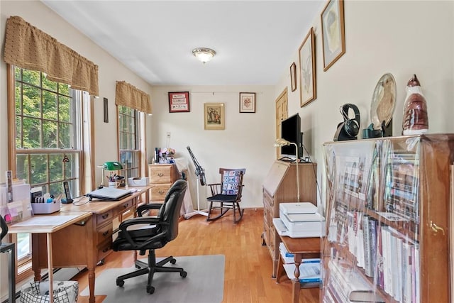 home office featuring light wood-type flooring and plenty of natural light