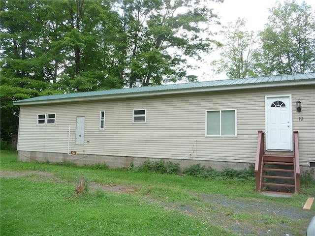 rear view of property with a yard