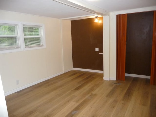 unfurnished room with hardwood / wood-style flooring