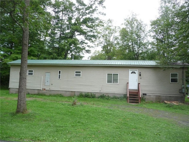 rear view of house with a yard