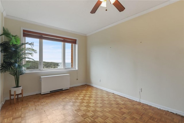 unfurnished room featuring ceiling fan, ornamental molding, radiator, and light parquet flooring