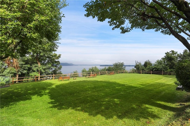 view of yard with a water view and a rural view