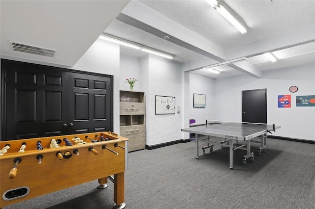 game room with carpet flooring and a textured ceiling