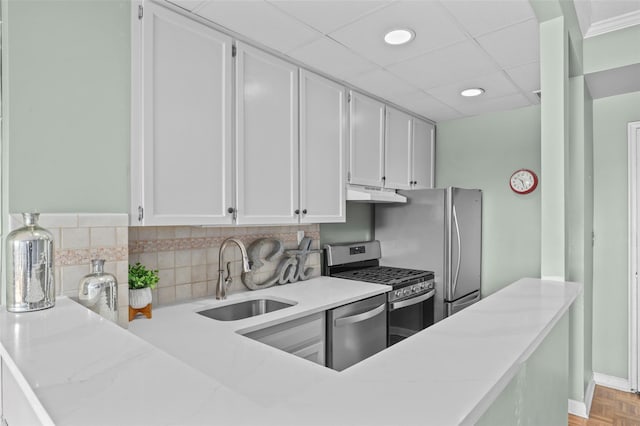 kitchen featuring light parquet floors, appliances with stainless steel finishes, white cabinetry, and sink