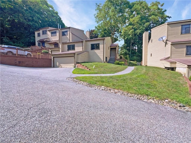 view of front of home featuring a garage and a front lawn