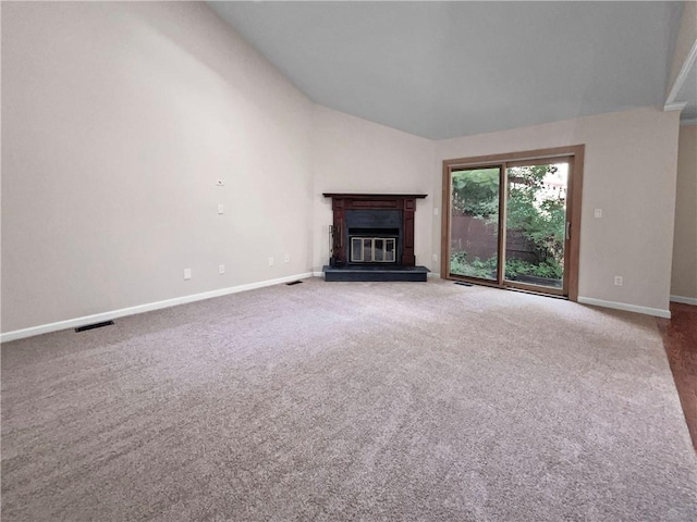 unfurnished living room with carpet flooring and lofted ceiling