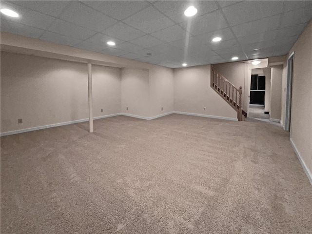 basement with carpet and a drop ceiling