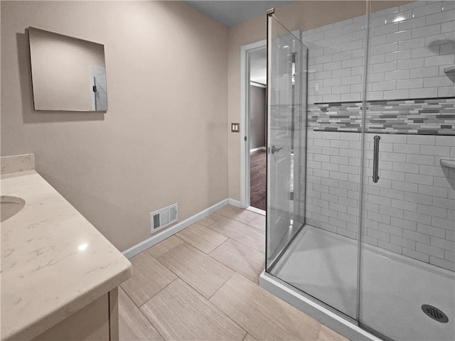 bathroom with vanity, tile patterned floors, and a shower with door