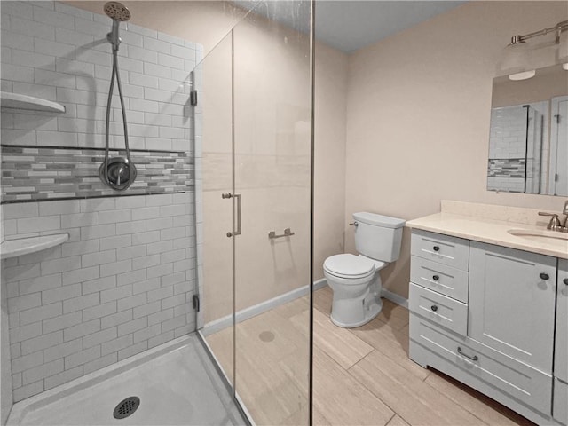 bathroom with vanity, toilet, and an enclosed shower