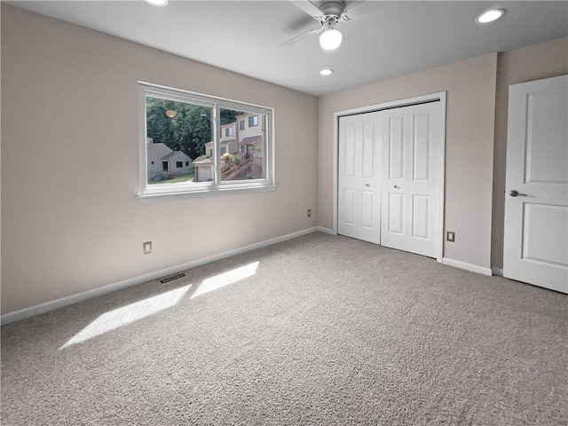 unfurnished bedroom with ceiling fan, a closet, and carpet floors