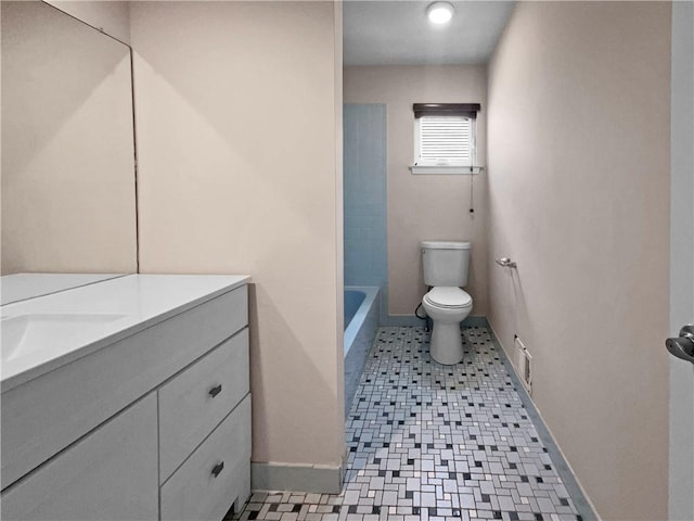 bathroom featuring tile patterned flooring, vanity, and toilet