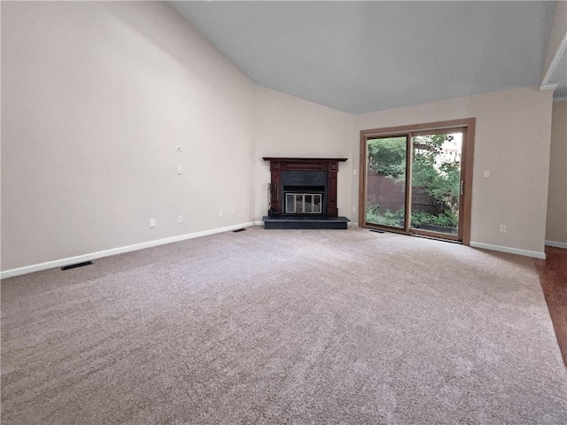 unfurnished living room with carpet and lofted ceiling