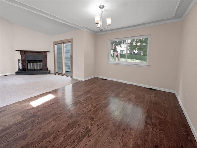 unfurnished living room featuring dark wood-type flooring and a chandelier