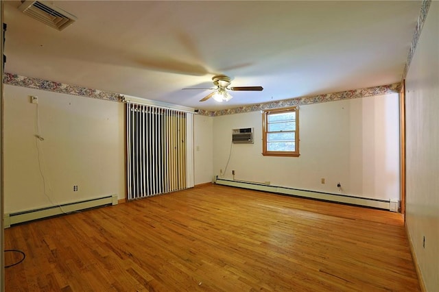 empty room with ceiling fan, light hardwood / wood-style floors, an AC wall unit, and baseboard heating