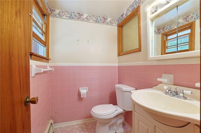 bathroom featuring vanity, toilet, and tile walls