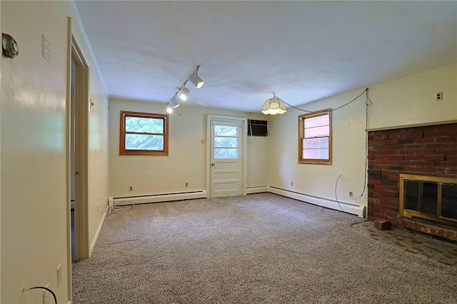 unfurnished living room with carpet, track lighting, and a baseboard heating unit