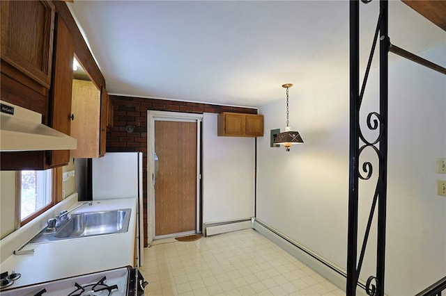 kitchen with a baseboard radiator, brick wall, ventilation hood, stove, and decorative light fixtures