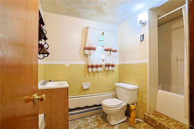 bathroom with tile patterned floors, vanity, toilet, and tile walls