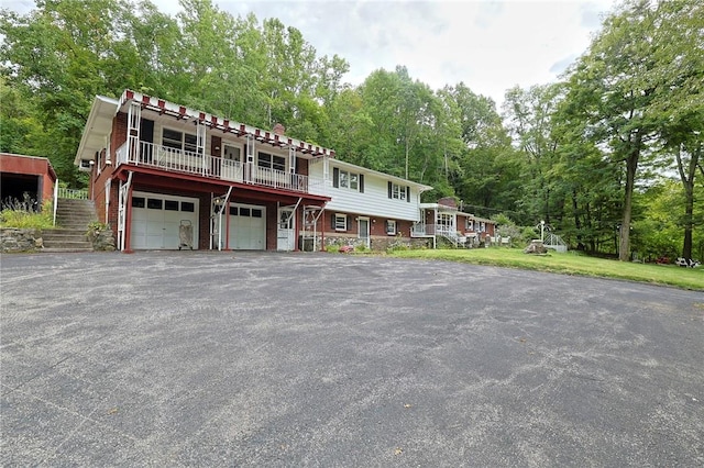 view of front of house with a garage and a deck