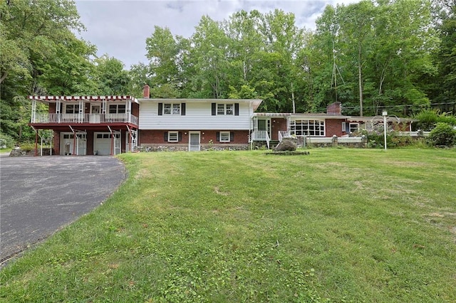 tri-level home with a front yard and a garage