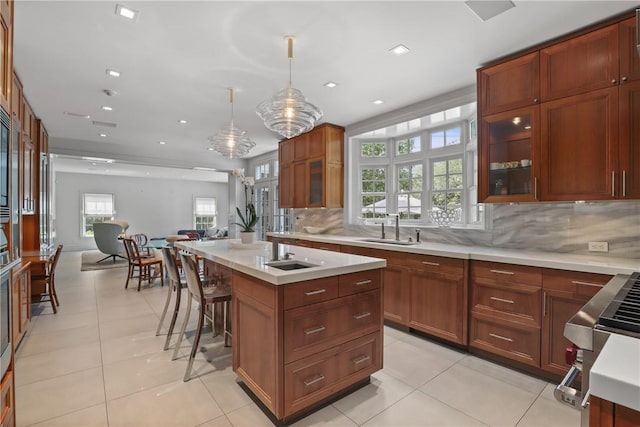 kitchen with light countertops, light tile patterned floors, and a sink