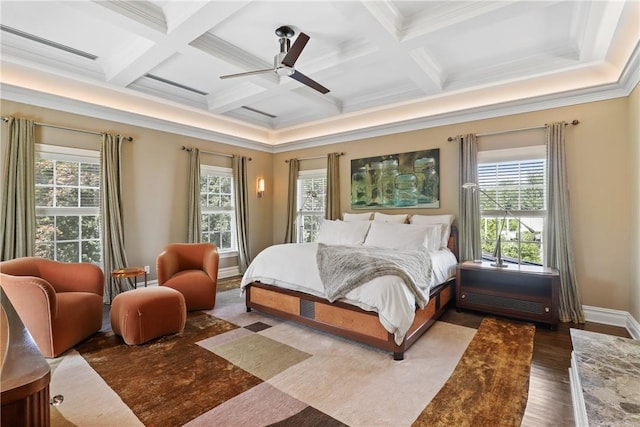 bedroom featuring crown molding, beam ceiling, wood finished floors, coffered ceiling, and a ceiling fan