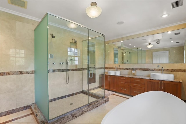 full bathroom featuring visible vents, a stall shower, tile walls, and a sink