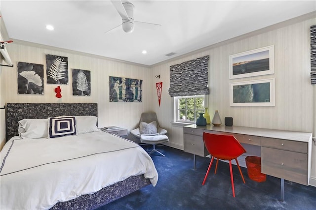 carpeted bedroom with a ceiling fan, visible vents, and built in study area